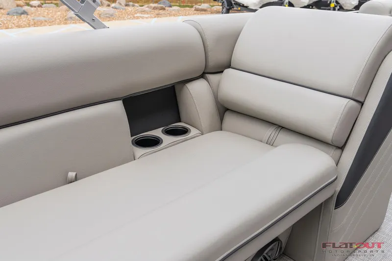 Slide: The Image of 2023 South Bay L-Lounge Tri-Toon 150HP boat interior with beige seating and cup holders. - 11