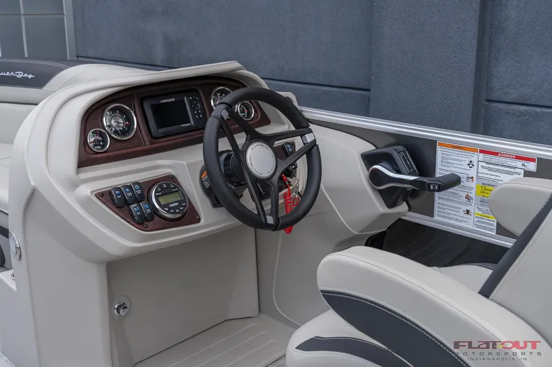 Slide: The Image of 2023 South Bay L-Lounge Tri-Toon 150HP boat dashboard and steering wheel. - 15
