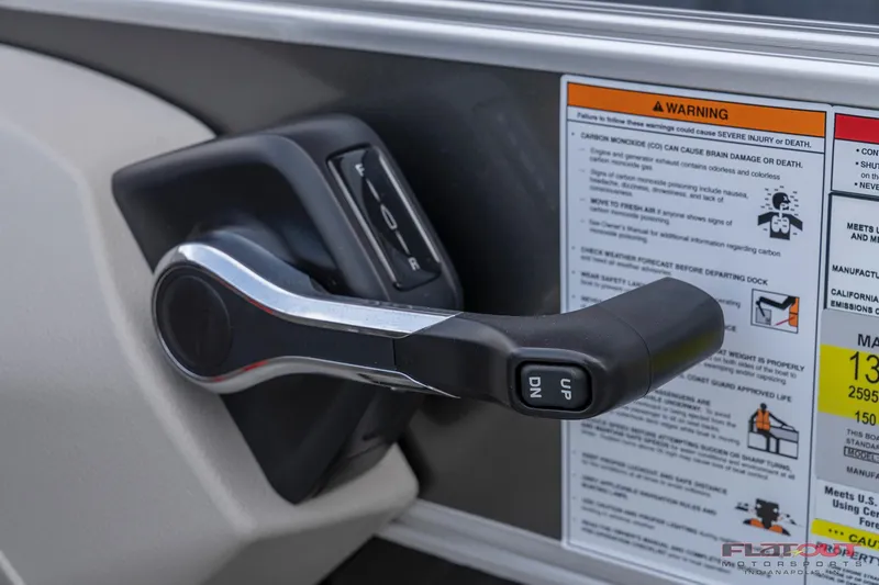 Slide: The Image of Close-up of the throttle control on a 2023 South Bay L-Lounge Tri-Toon 150HP boat. - 21