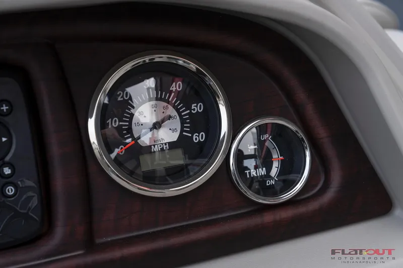Slide: The Image of Close-up of 2023 South Bay L-Lounge Tri-Toon 150HP speedometer and trim gauge. - 28