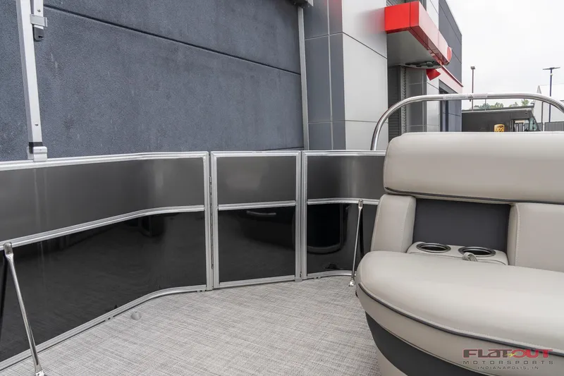 Slide: The Image of 2023 South Bay L-Lounge Tri-Toon 150HP boat interior with gray seating and cup holders. - 3