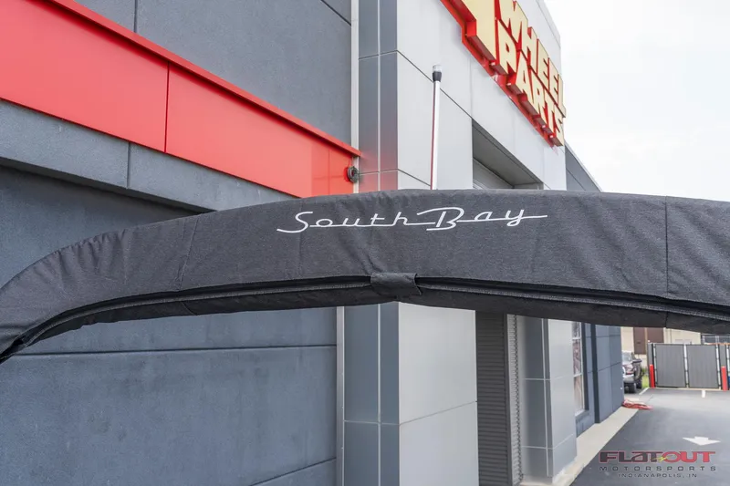 Slide: The Image of 2023 South Bay L-Lounge Tri-Toon 150HP boat canopy at dealership. - 31