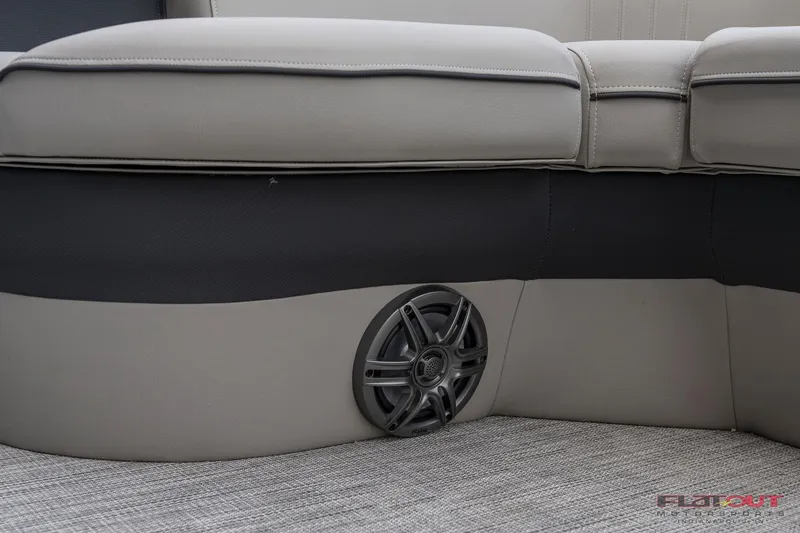 Slide: The Image of 2023 South Bay L-Lounge Tri-Toon 150HP boat interior with speaker and cushioned seating. - 32