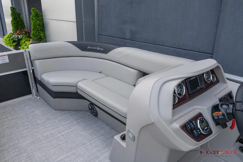 Slide: The Image of 2023 South Bay L-Lounge Tri-Toon 150HP boat interior with plush seating and modern dashboard. - 35