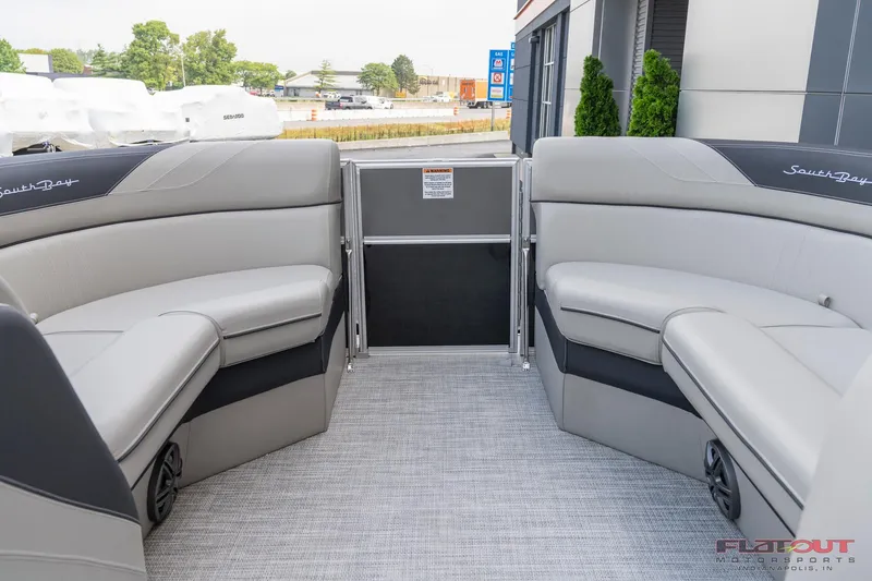 Slide: The Image of 2023 South Bay L-Lounge Tri-Toon 150HP interior with gray seating and flooring. - 36