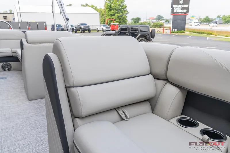 Slide: The Image of 2023 South Bay L-Lounge Tri-Toon 150HP boat with luxurious seating and cup holders. - 39