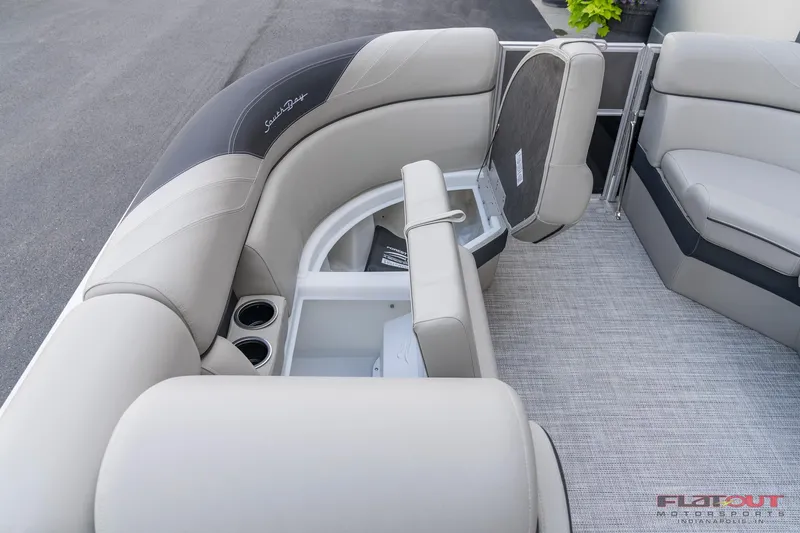Slide: The Image of 2023 South Bay L-Lounge Tri-Toon 150HP interior with storage compartments and cup holders. - 41