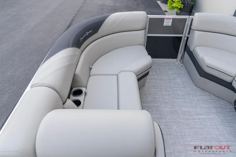 Slide: The Image of 2023 South Bay L-Lounge Tri-Toon 150HP boat interior with plush seating and cup holders. - 42