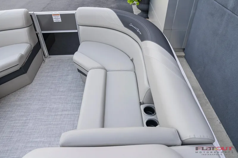 Slide: The Image of 2023 South Bay L-Lounge Tri-Toon 150HP boat interior with plush seating and cup holders. - 44