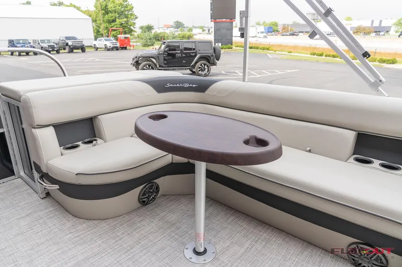 Slide: The Image of 2023 South Bay L-Lounge Tri-Toon 150HP interior with seating and table. - 45