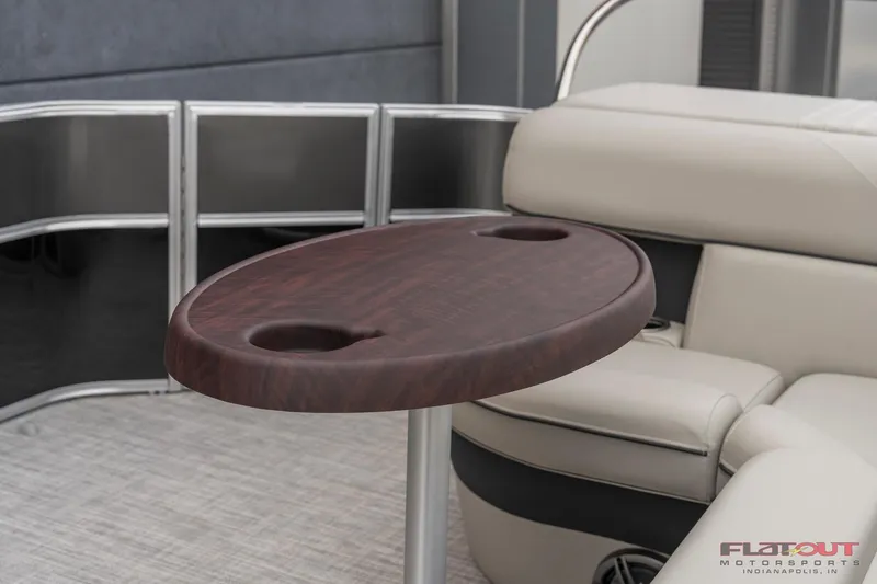 Slide: The Image of 2023 South Bay L-Lounge Tri-Toon 150HP interior with wooden table and cushioned seating. - 46