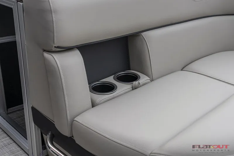 Slide: The Image of 2023 South Bay L-Lounge Tri-Toon 150HP boat with comfortable seating and built-in cup holders. - 7