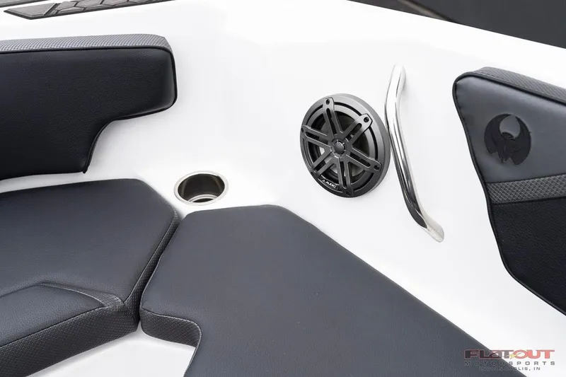 Slide: The Image of 2023 Scarab 215 ID boat interior with black seating, speaker, and cup holder. - 12
