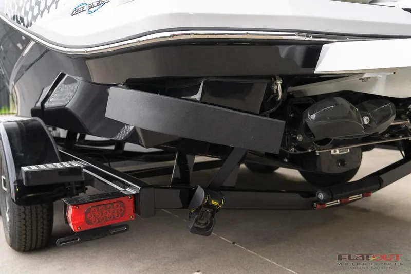 Slide: The Image of 2023 Scarab 215 ID boat on trailer, rear view showing engine and propeller. - 15