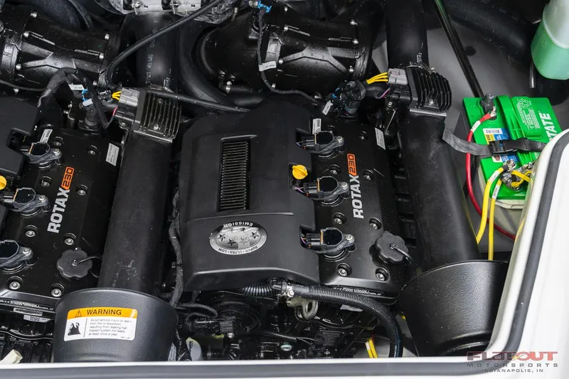 Slide: The Image of 2023 Scarab 215 ID engine compartment with Rotax 200 engines and battery. - 26