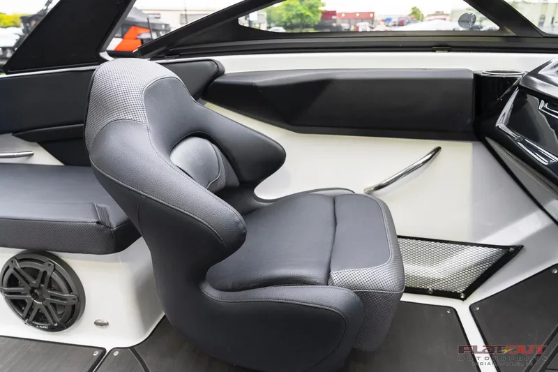 Slide: The Image of 2023 Scarab 215 ID boat interior with black captain's chair and modern dashboard. - 29