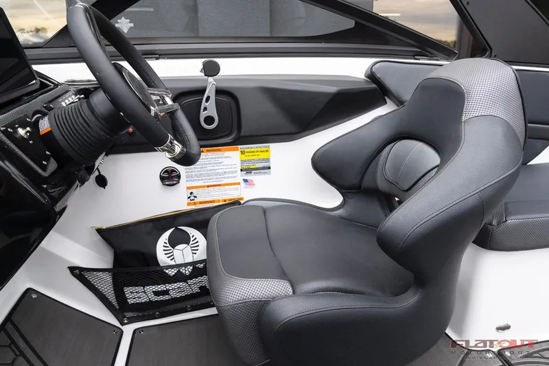 Slide: The Image of 2023 Scarab 215 ID boat cockpit with steering wheel and captain's seat. - 32