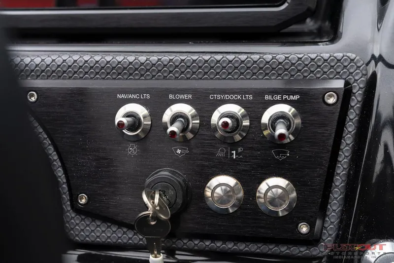 Slide: The Image of Control panel of 2023 Scarab 215 ID boat with switches and key ignition. - 34
