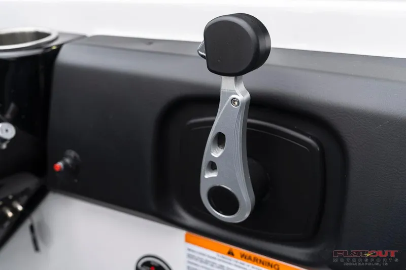 Slide: The Image of Close-up of the throttle control on a 2023 Scarab 215 ID boat. - 37
