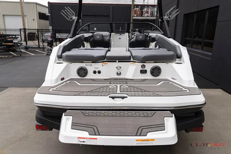 Slide: The Image of 2023 Scarab 215 ID boat rear view with seating and deck features. - 4