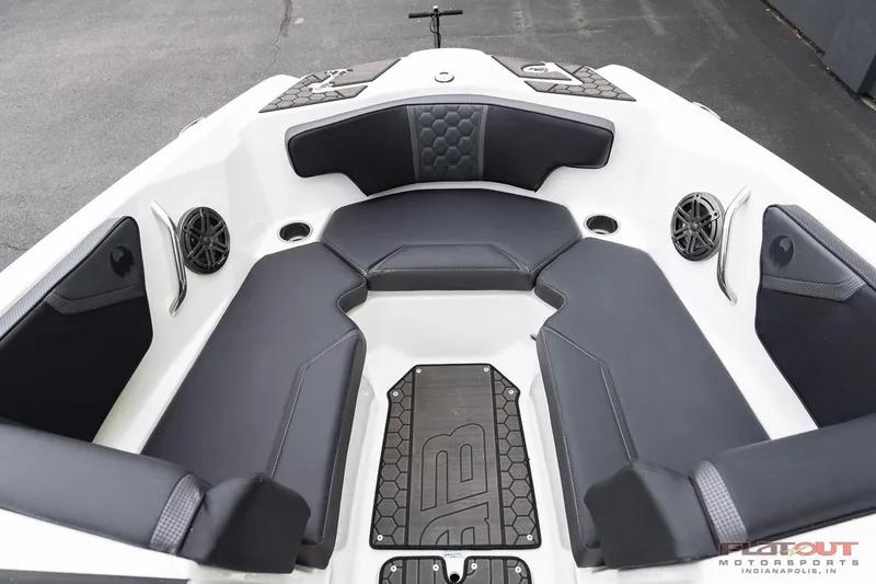 Slide: The Image of 2023 Scarab 215 ID boat interior with black and white seating and speakers. - 6