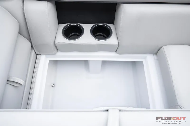 Slide: The Image of 2023 South Bay 224RSLE275 boat interior with cup holders and storage compartment. - 19