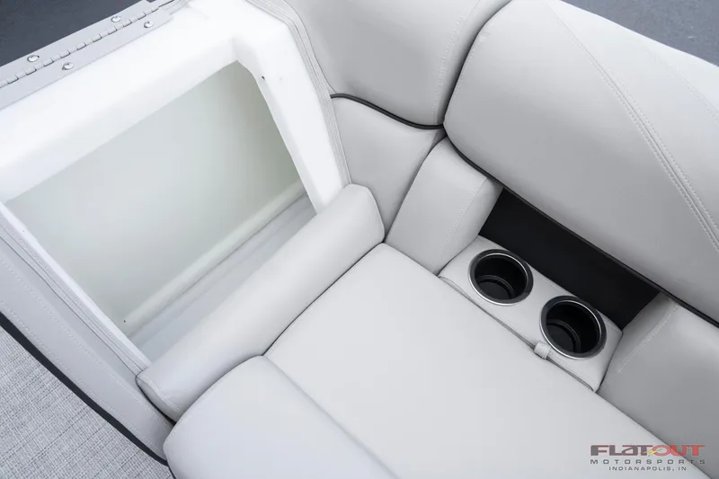 Slide: The Image of 2023 South Bay 224RSLE275 boat interior with storage compartment and cup holders. - 20
