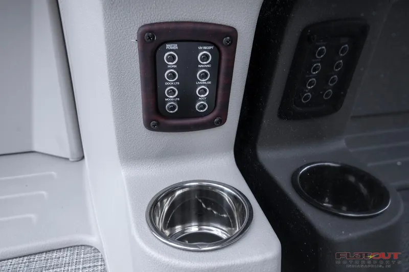 Slide: The Image of Control panel and cup holder in 2023 South Bay 224RSLE275 boat. - 22
