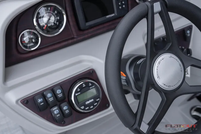 Slide: The Image of 2023 South Bay 224RSLE275 boat dashboard with steering wheel and control panel. - 8