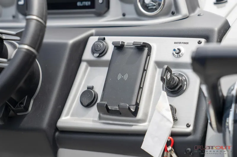 Slide: The Image of Control panel of 2023 South Bay 525 3.0 Entertain 200HP boat with phone holder. - 12