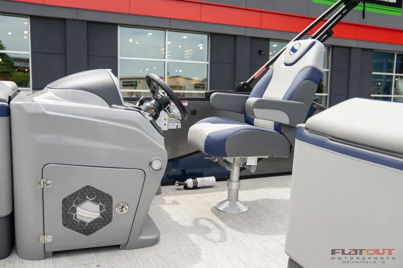Slide: The Image of 2023 South Bay 525 3.0 Entertain 200HP boat interior with captain's chair and control console. - 15