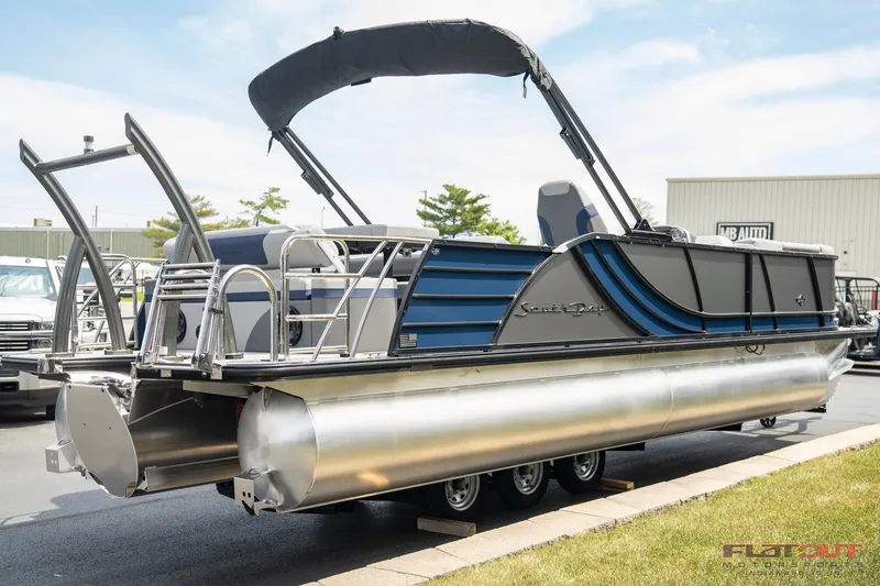 Slide: The Image of 2023 South Bay 525 3.0 Entertain 200HP pontoon boat with canopy, docked on pavement. - 3