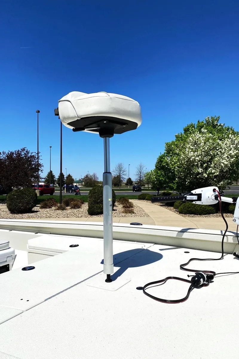 Slide: The Image of 2023 Ranger RB190 boat seat on deck, clear sky, and landscaped background. - 10