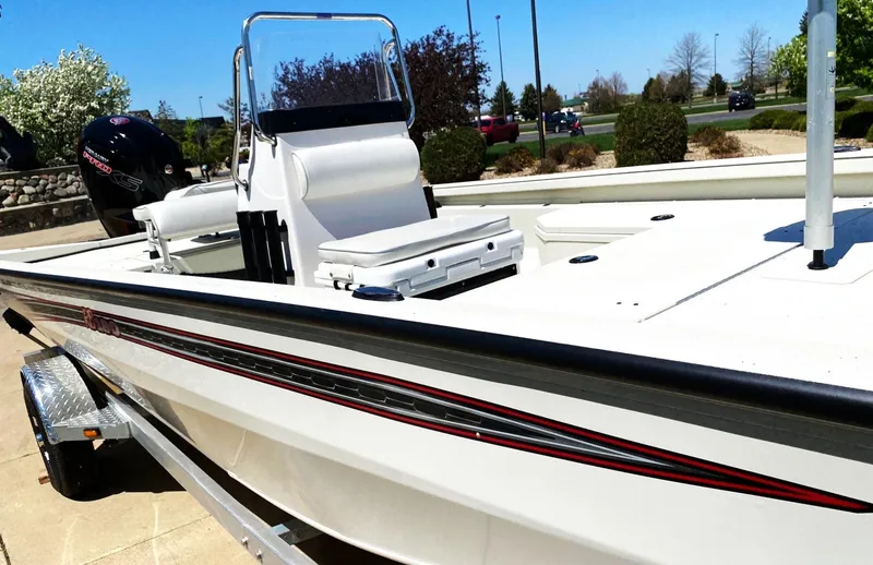 Slide: The Image of 2023 Ranger RB190 boat on trailer, white with red accents, parked outdoors. - 13