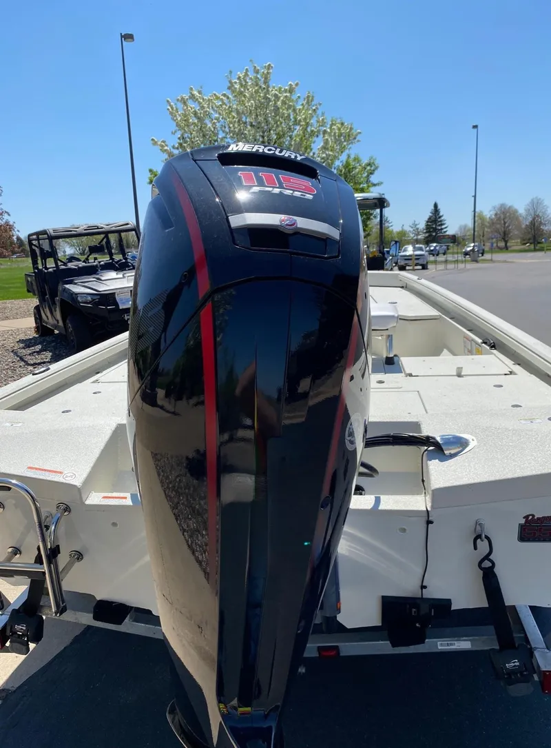 Slide: The Image of 2023 Ranger RB190 boat with Mercury outboard motor, parked outdoors on a sunny day. - 15