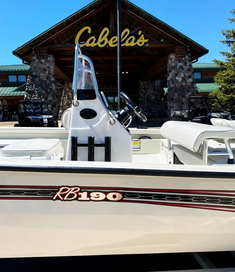 Slide: The Image of 2023 Ranger RB190 boat displayed outside Cabela's store. - 2