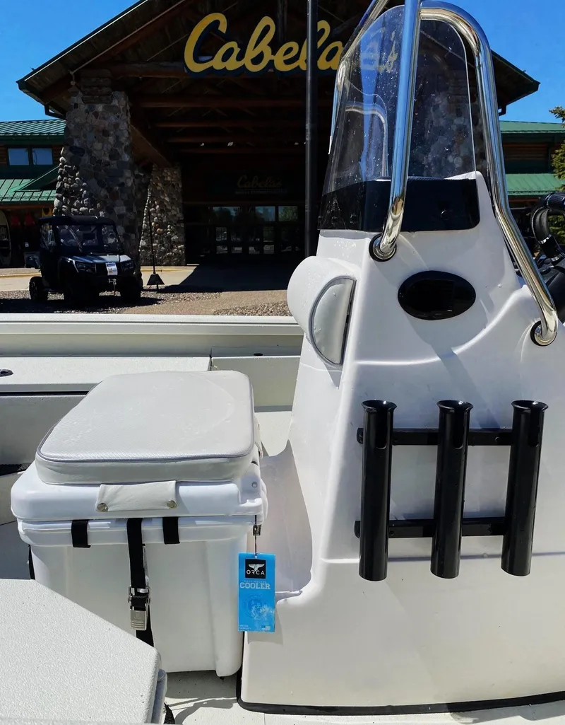 Slide: The Image of 2023 Ranger RB190 boat at Cabela's store, featuring rod holders and seating. - 4