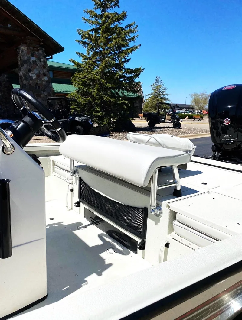 Slide: The Image of 2023 Ranger RB190 boat interior with seating and steering wheel, outdoors. - 5