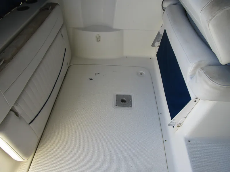 Slide: The Image of 2005 Bayliner 285 boat interior with white seating and flooring. - 13