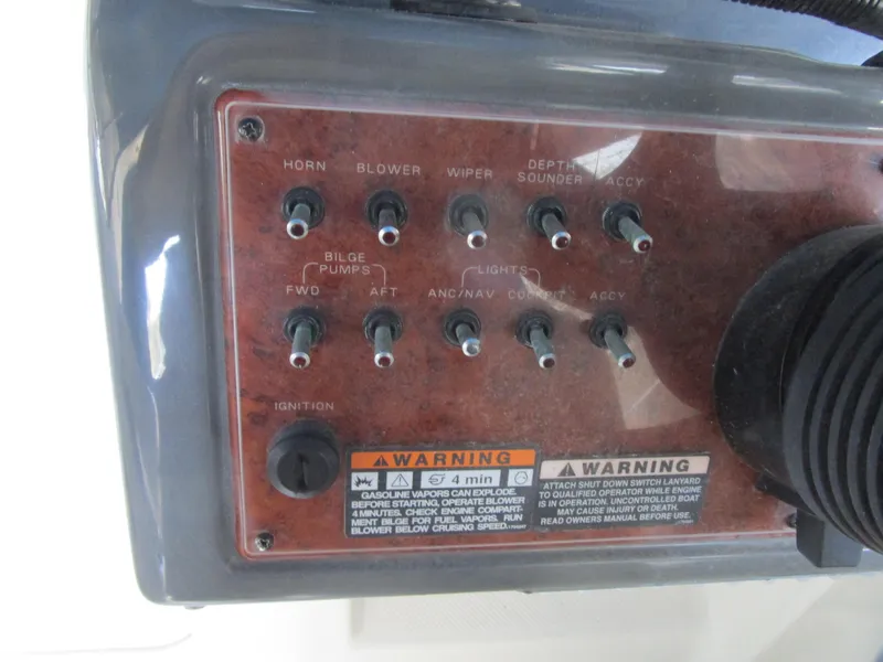 Slide: The Image of Control panel of a 2005 Bayliner 285 boat with various switches and warnings. - 8