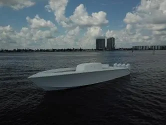 Slide: The Image of Sleek 2025 Sparks 46 boat on calm water under a cloudy sky. - 3