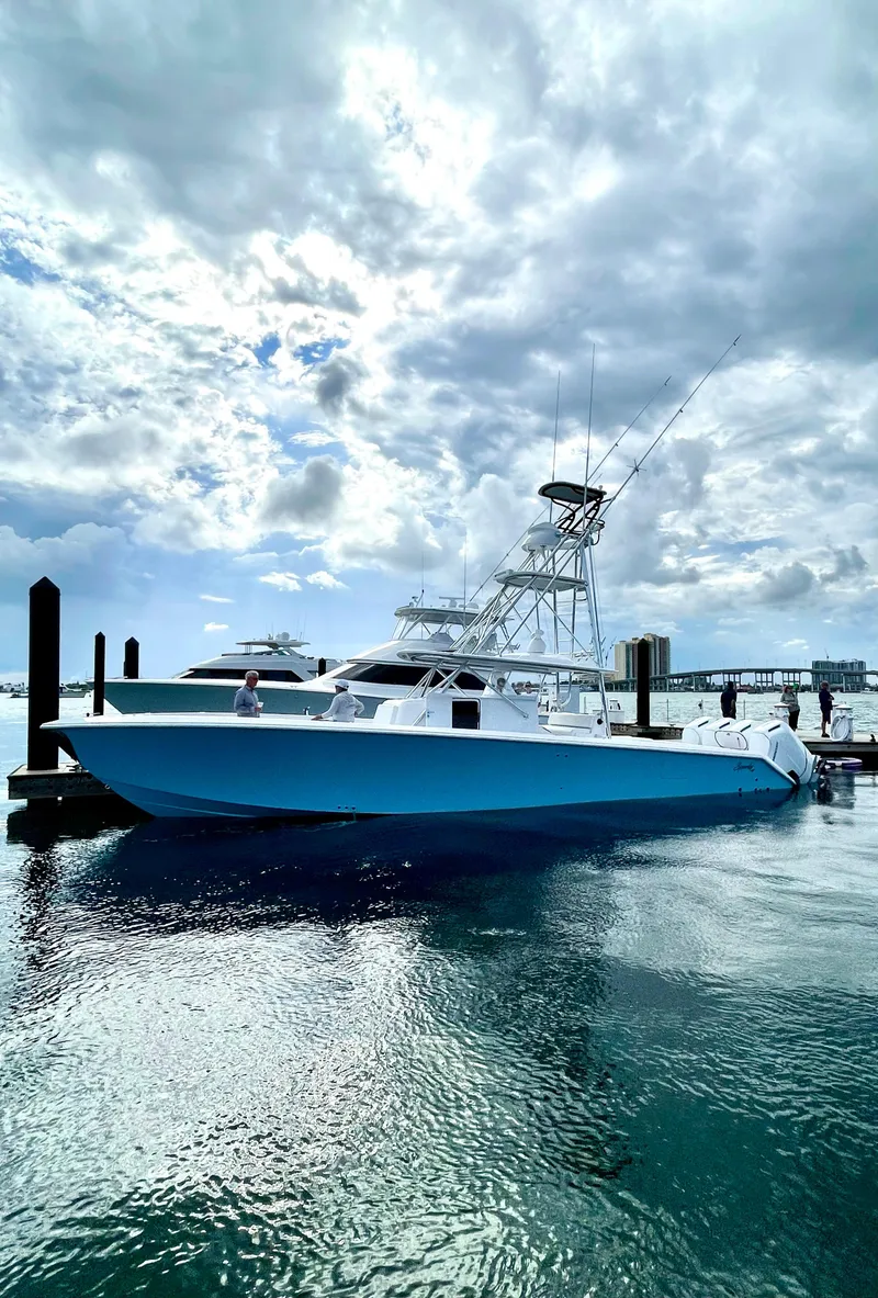 Slide: The Image of 2023 Sparks 46 boat docked at a marina under a cloudy sky. - 38