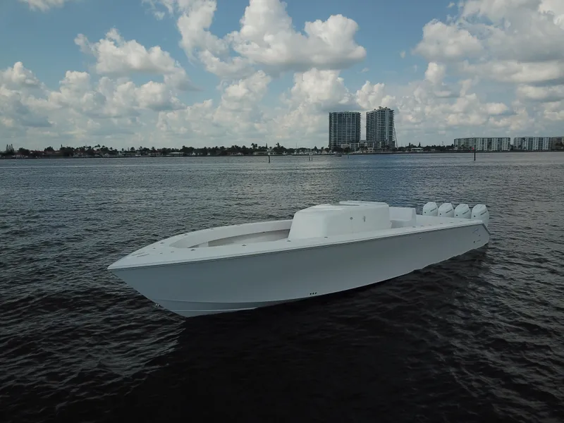 Slide: The Image of Sparks 46 boat on water, 2025 model, with city skyline and clouds in background. - 39