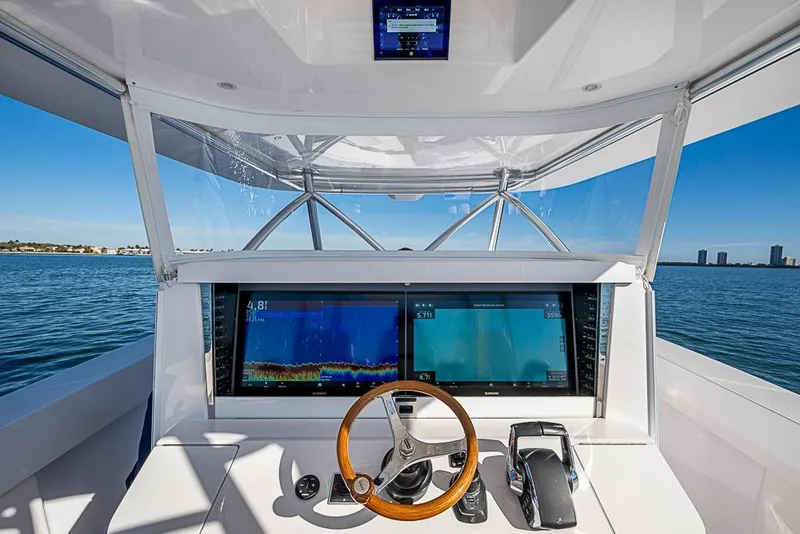 Slide: The Image of Interior view of Sparks 46 boat, 2026 model, featuring modern helm console. - 47