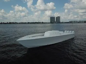Slide: The Image of Sleek 2025 Sparks 46 boat on calm water with cityscape background. - 59