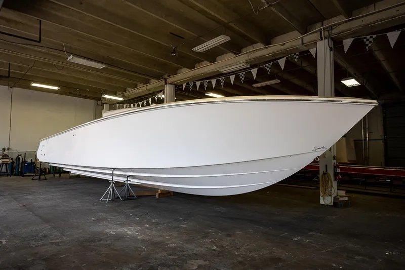 Slide: The Image of 2023 Sparks 46 boat in a warehouse, side view. - 65
