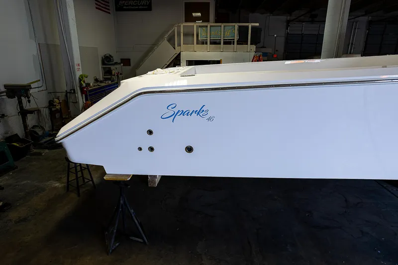 Slide: The Image of 2023 Sparks 46 boat in a workshop, side view. - 84