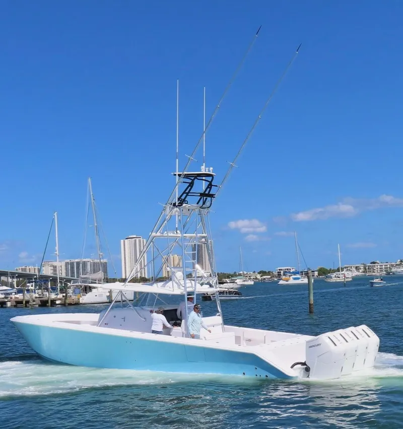 Slide: The Image of 2023 Sparks 46 boat cruising in a marina with cityscape background. - 88