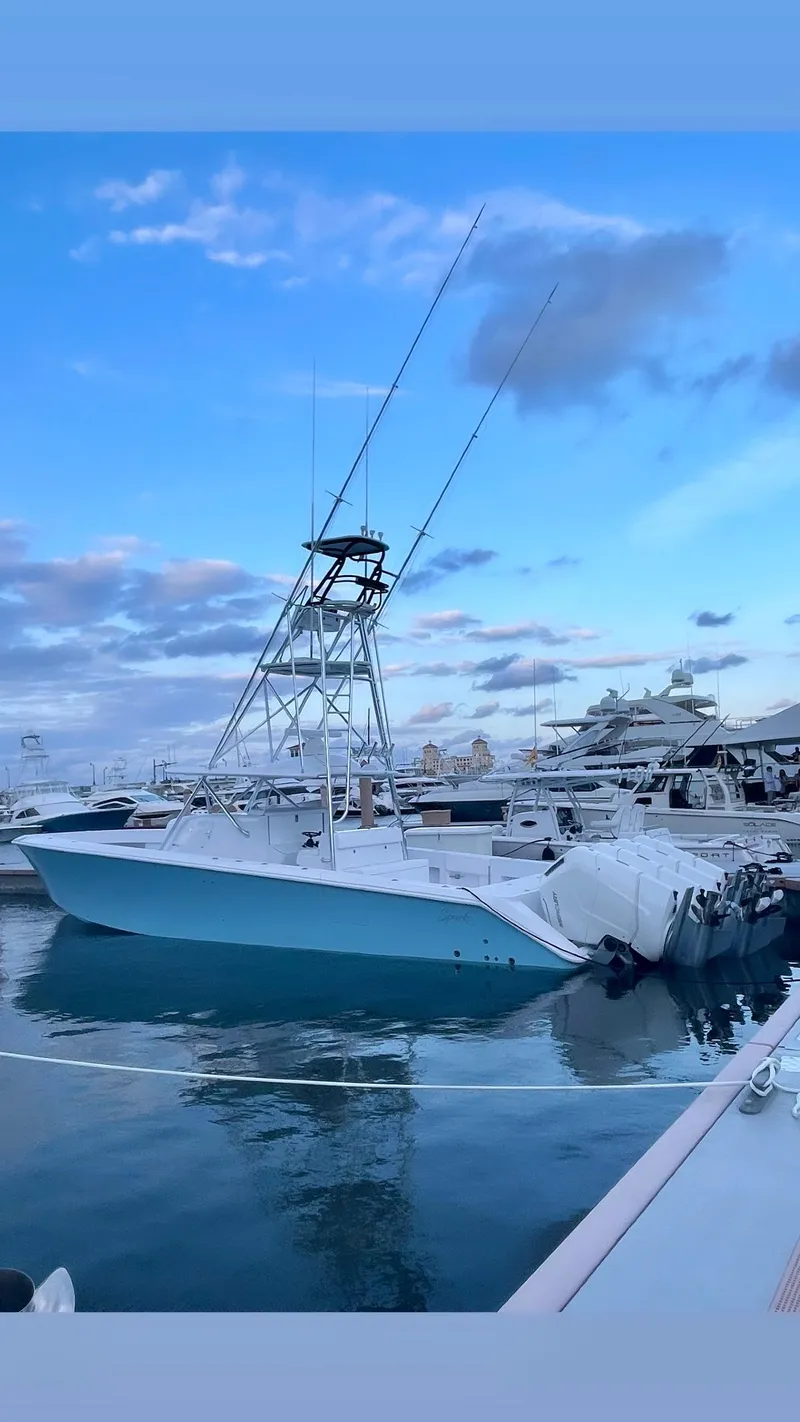 Slide: The Image of 2023 Sparks 46 boat docked at marina under blue sky. - 89