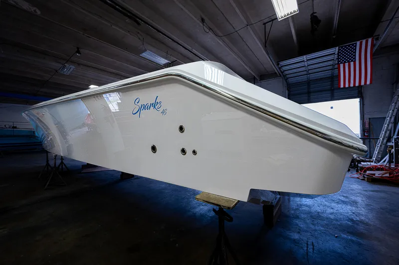 Slide: The Image of 2026 Sparks 46 boat with four engines on a sunny day, cruising on a calm lake. - 9